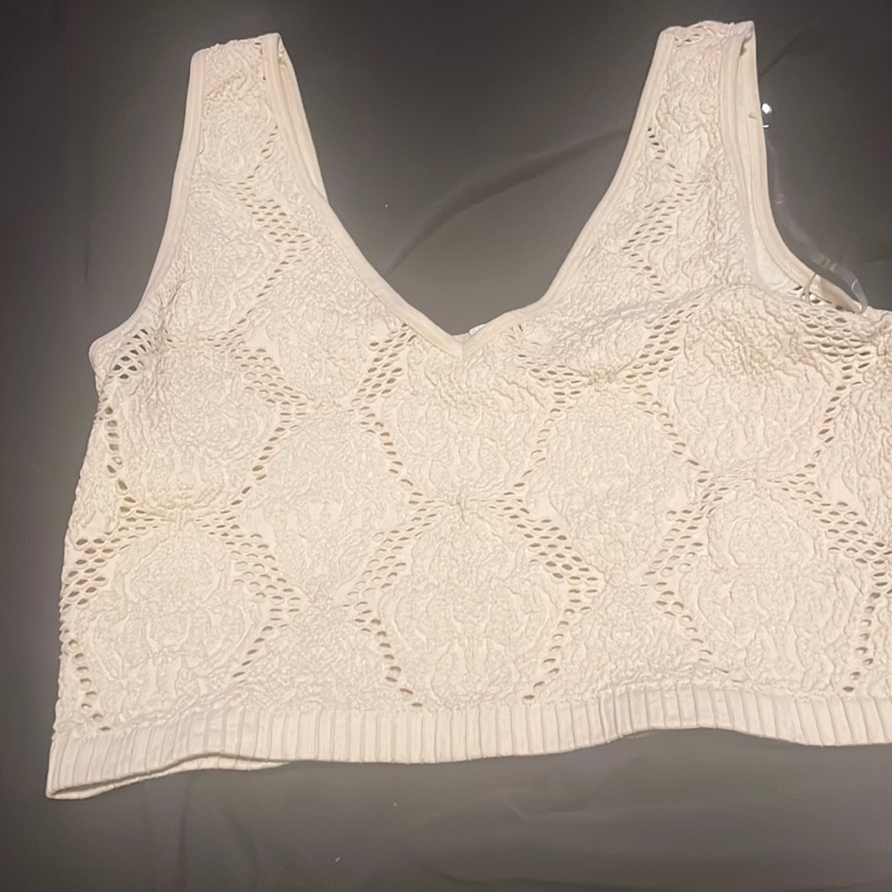 Beige fitted crop top.